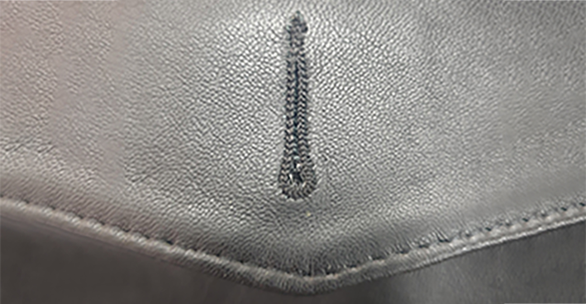 a sewn button hole on a leather jacket